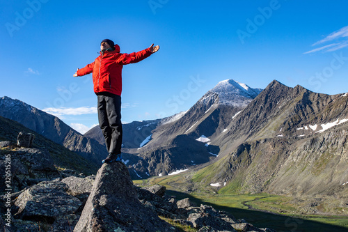 Tourist on the background of the mountain landscape of the polar Urals of Russia. Inaccessible mountains of the national park