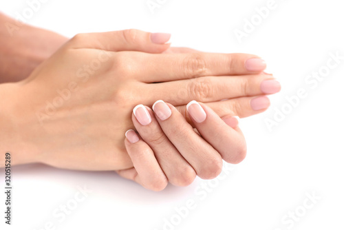 Beautiful woman hands with french manicure on a white background