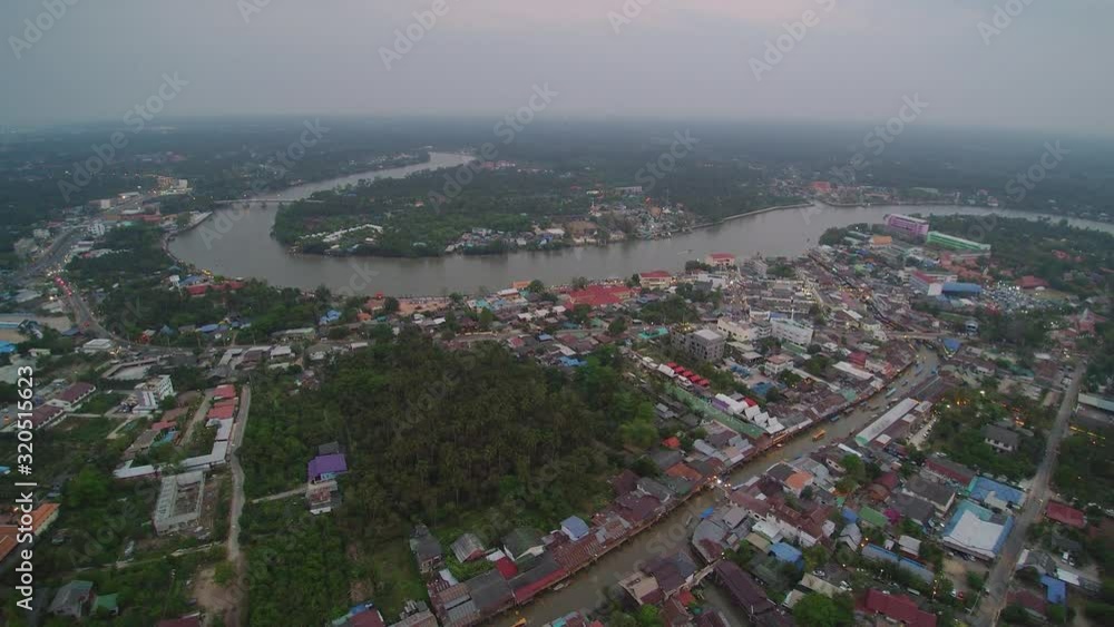 VDO. Aerial view evening above canal, houses, buildings and river with blue sky background, Amphawa Floating Market, Samut Songkhram, Thailand.
