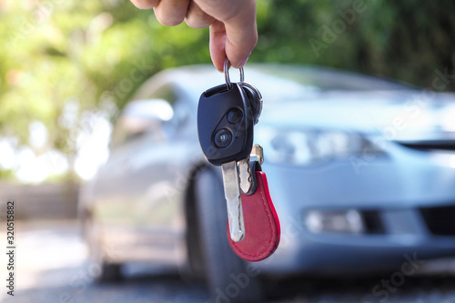 Tableau sur toile The car owner is standing the car keys to the buyer