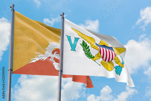 United States Virgin Islands and Bhutan flags waving in the wind against white cloudy blue sky together. Diplomacy concept, international relations. photo