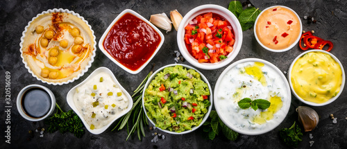 Selection of sauces in white bowls on white bowls, top view