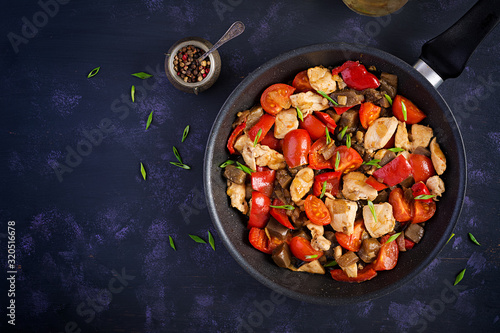 Chicken stir fry. Meat stew with vegetables sweet pepper, onion, tomato, eggplant  in soy sauce gravy. Ketogenic diet. Top view, overhead, copy space