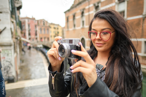 Travel woman photographer in Venice taking picture outside smiling © ZoomTeam