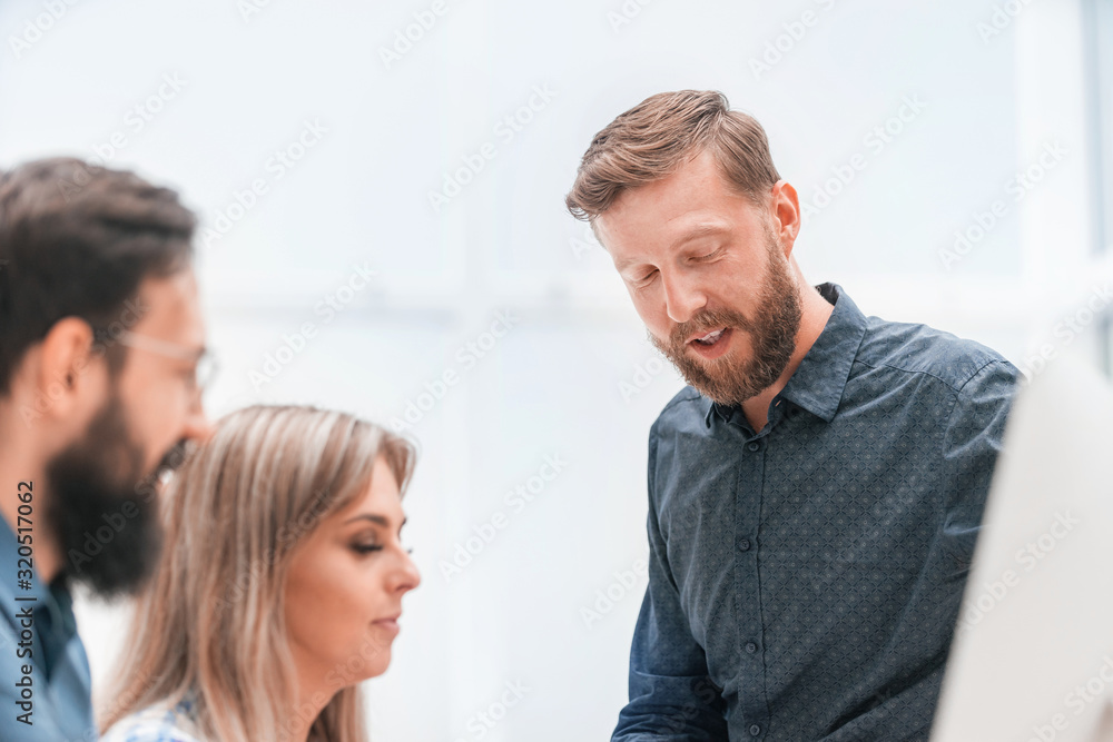 close up. smiling businessman talking to colleagues. close up. smiling businessman talking to colleagues.