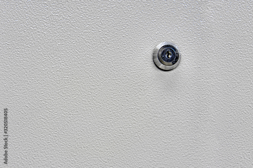 Keyhole on a painted metal door, close-up background and copy space for text Keyhole on a painted metal door, close-up background and copy space for text