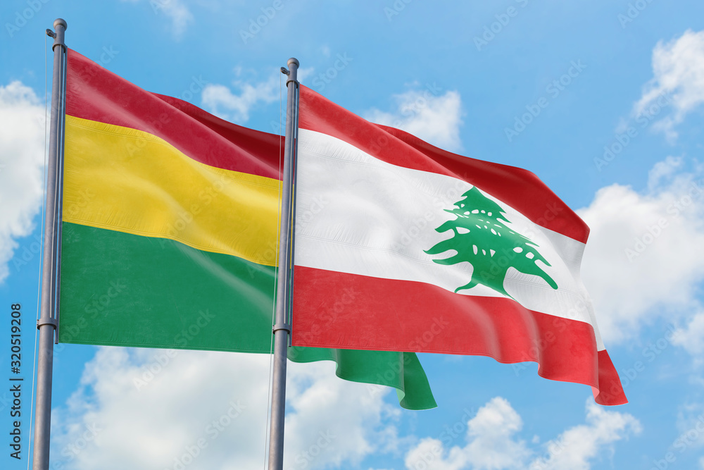 Lebanon and Bolivia flags waving in the wind against white cloudy blue sky together. Diplomacy concept, international relations. Lebanon and Bolivia flags waving in the wind against white cloudy blue sky together. Diplomacy concept, international relations.