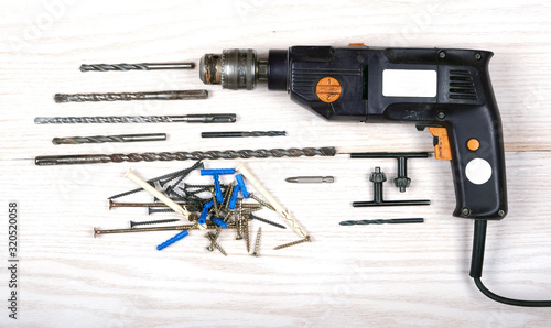 electric drill and drill bits of various diameters and self-tapping screws