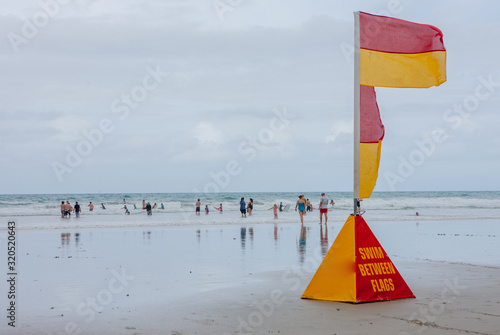 Ruakaka coast. New Zealand. Beach and ocean. Warning for swimming. Flag warning. Swim between flags. Beach life.  photo