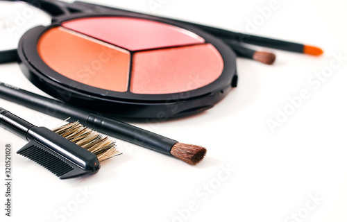 Make-up brushes and cosmetics isolated on a white background.