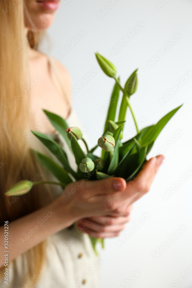 Conceptual image of a woman holding spring flowers as present for international women's day. Close up, copy space, background. Conceptual image of a woman holding spring flowers as present for international women's day. Close up, copy space, background.
