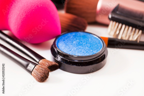 Make-up brushes and cosmetics isolated on a white background.