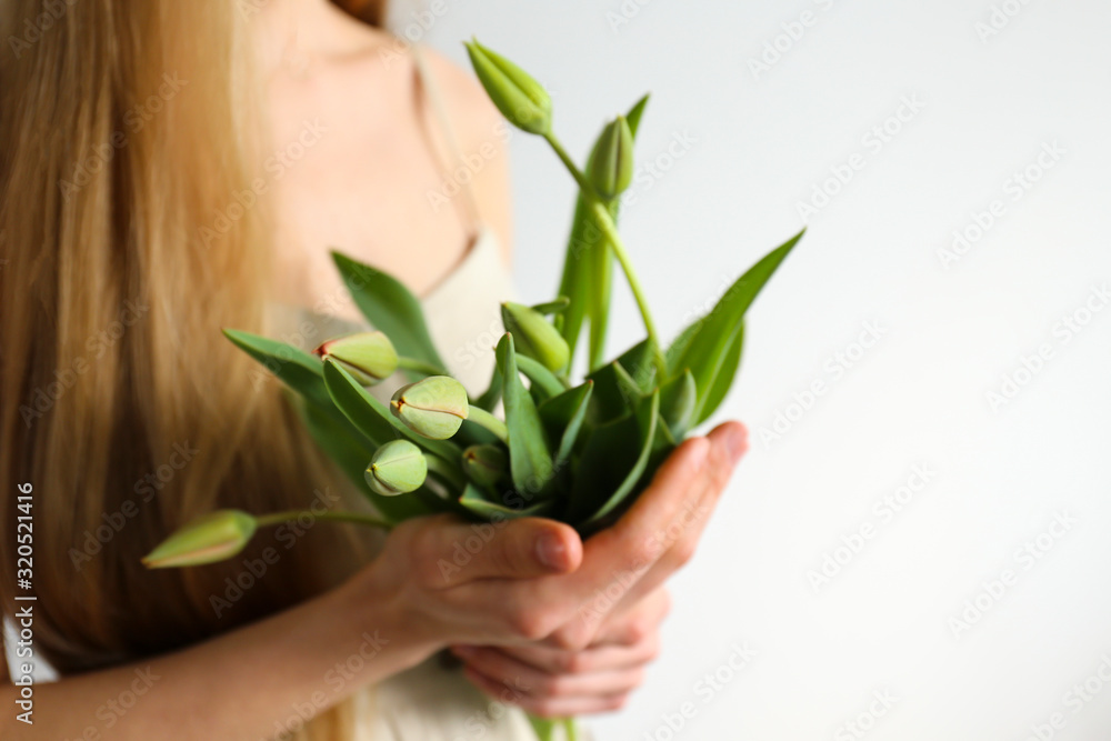 Conceptual image of a woman holding spring flowers as present for international women's day. Close up, copy space, background. Conceptual image of a woman holding spring flowers as present for international women's day. Close up, copy space, background.