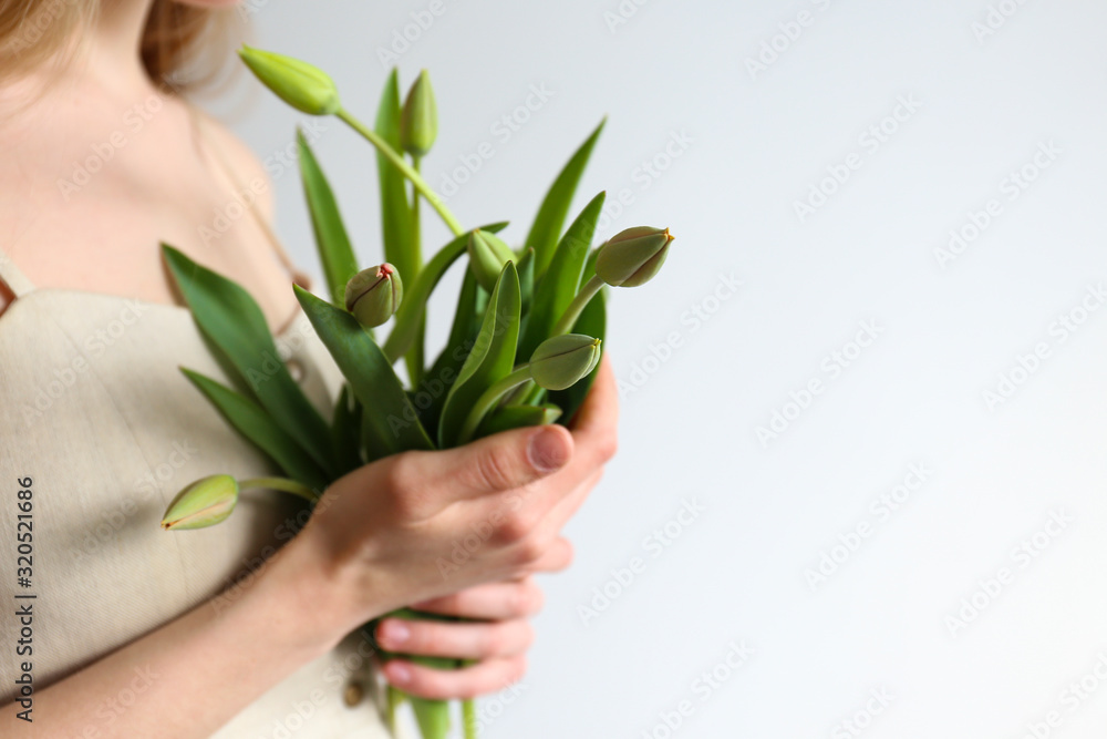 Conceptual image of a woman holding spring flowers as present for international women's day. Close up, copy space, background. Conceptual image of a woman holding spring flowers as present for international women's day. Close up, copy space, background.