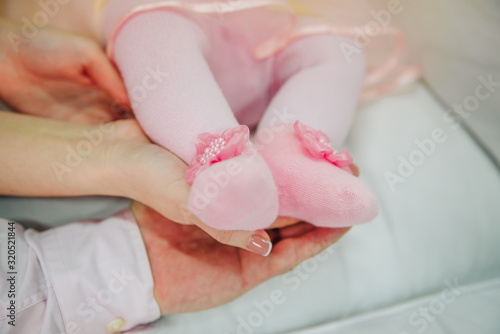 Family photo of baby feet in parents hands