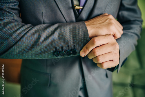 Gray sleeve on a classic men's suit with buttons