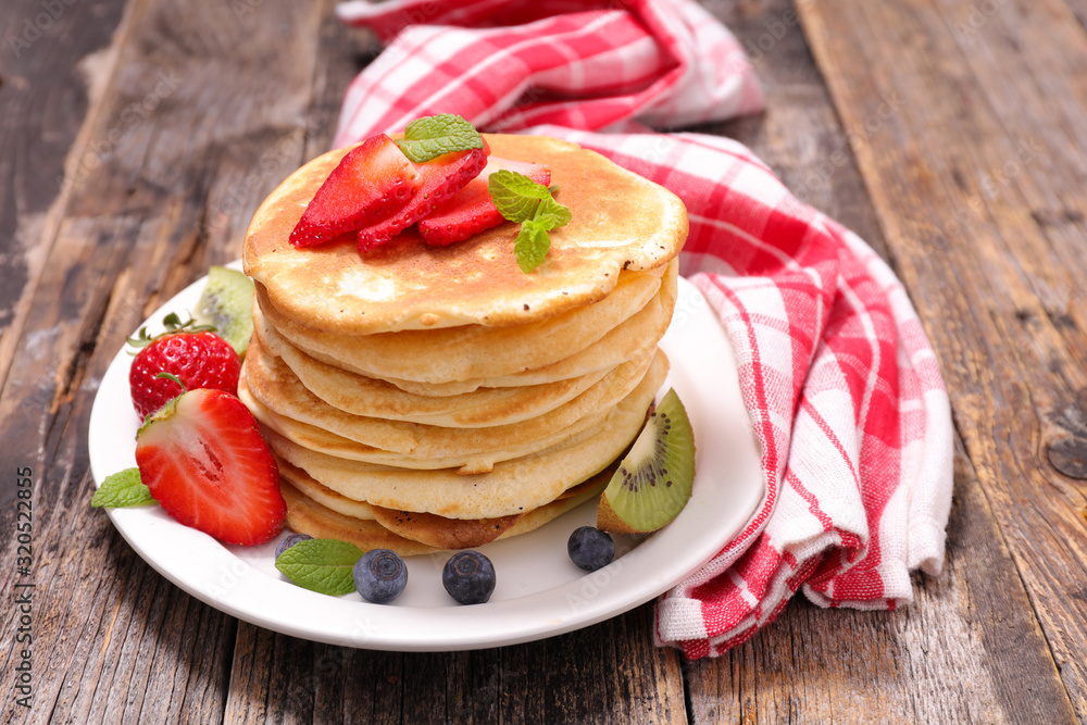 stack of pancakes with berry fruit