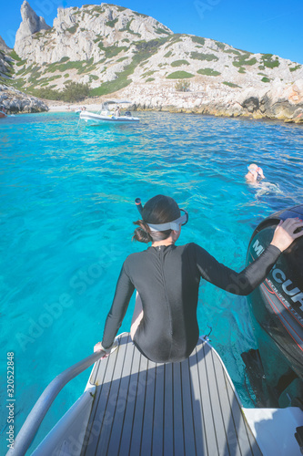 Marseille, France - August 13th, 2019:People are swimming and diving in Calanques de Morgiou, Marseilles, Provence, South of France.  Everyone looks very cheerful and happy.