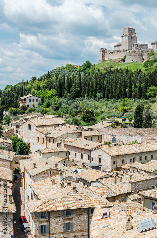 A view of the religious pilgrimage city of Assisi in Italy. In the background, the Rocca Maggiore castle.