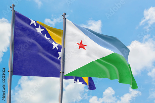 Djibouti and Bosnia Herzegovina flags waving in the wind against white cloudy blue sky together. Diplomacy concept, international relations.
