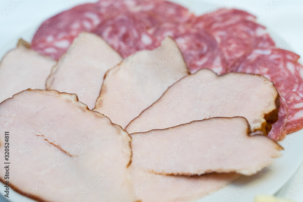 cold cuts of boiled pork and smoked sausage on a plate