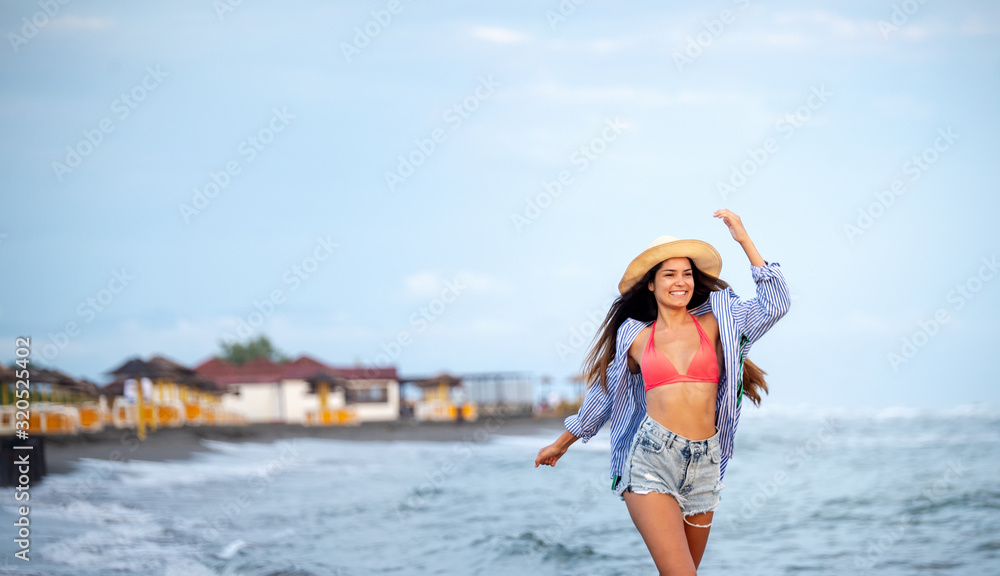 Beautiful girl on the beach at sunset. Summer, travel, vacation concept Beautiful girl on the beach at sunset. Summer, travel, vacation concept
