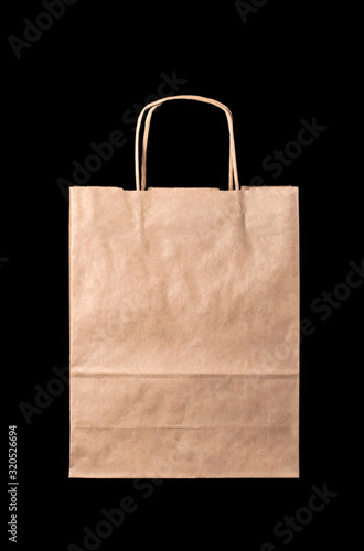 Brown paper bag with cardboard handles on a black background