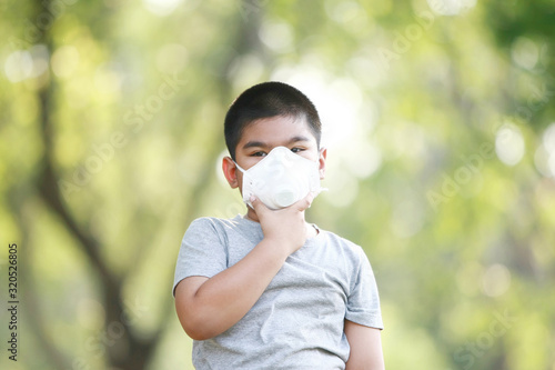 A young Asian boy wear mask to protect against dust PM 2.5 and germs