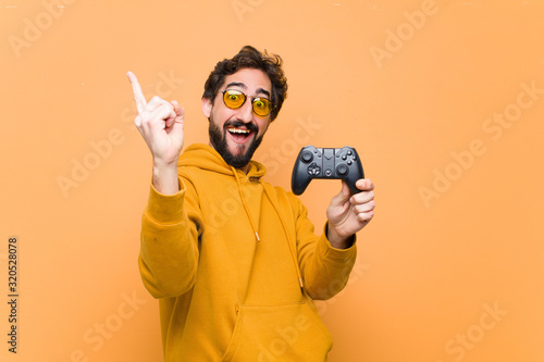 young crazy cool man paying with a game console controller photo