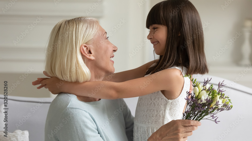 Happy little girl congratulate grandmother with special occasion Happy little girl congratulate grandmother with special occasion