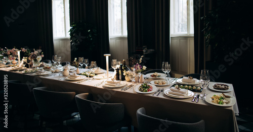 Elegant table set with food for a romantic dinner. Catering, hospitality and private dining