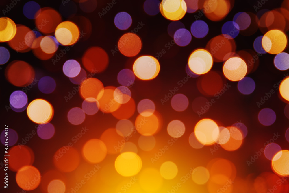 Yellow, purple, orange and red bokeh on a dark background. Beautiful blurry circles. Holiday lights. Yellow, purple, orange and red bokeh on a dark background. Beautiful blurry circles. Holiday lights.