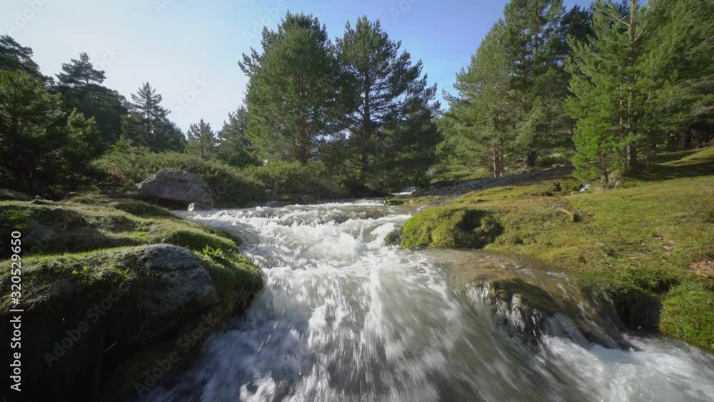 Rushing stream under snow mountain Rushing stream under snow mountain