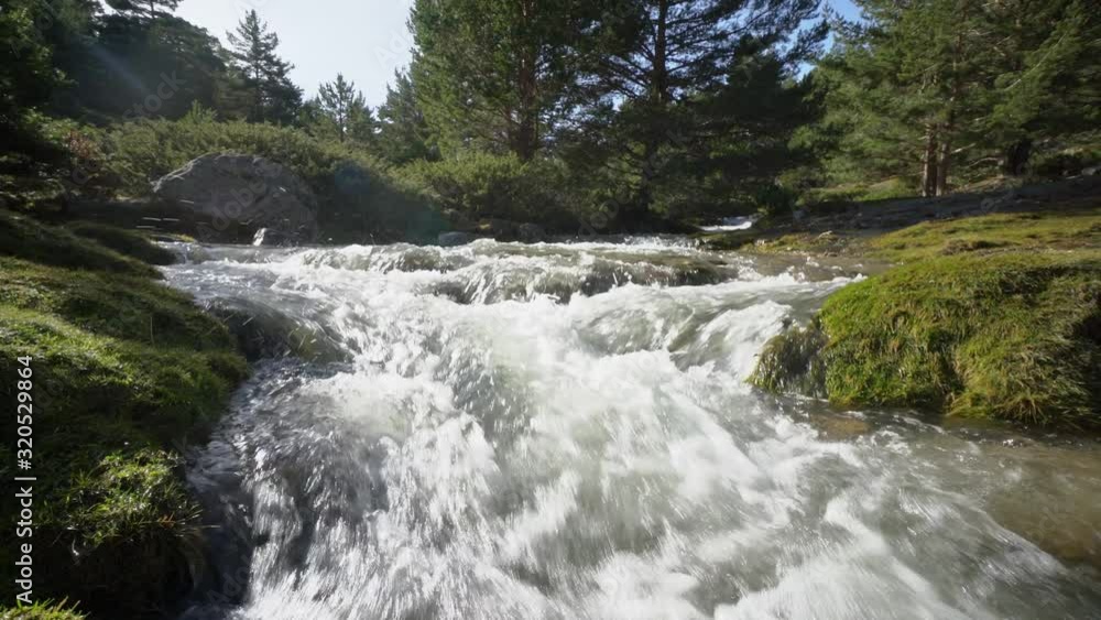 Rushing stream under snow mountain Rushing stream under snow mountain