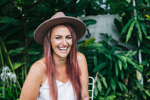 Gorgeous laughing woman looking at camera in garden
