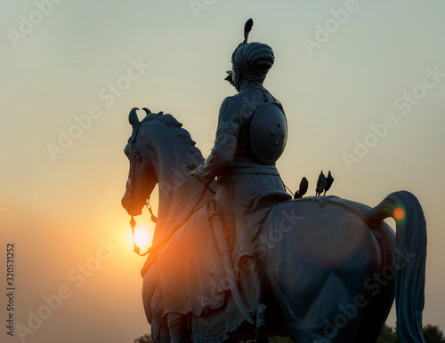 Statue of Rao Jodha in the rays of the sunset in Jodhpur, India © Konstantin