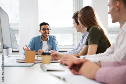 Multy-ethnic group of young business people working with computer at office