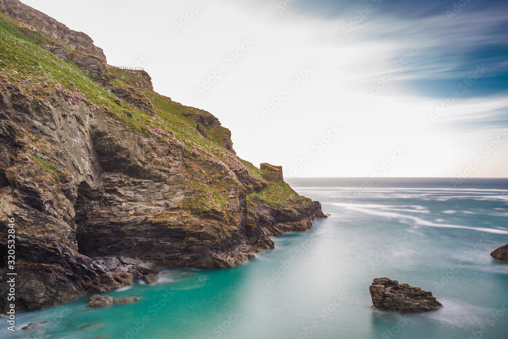 The ruins of Tintagel Castle on Tintagel Island at sunset. Cornwall. UK.