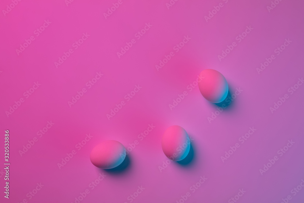 Egg hunt is coming. Easter traditions, pink-blue colored eggs on pink background, neon light, top view, copyspace for ad. Concept of holidays, spring, celebrating, food and sweets, family time. Egg hunt is coming. Easter traditions, pink-blue colored eggs on pink background, neon light, top view, copyspace for ad. Concept of holidays, spring, celebrating, food and sweets, family time.