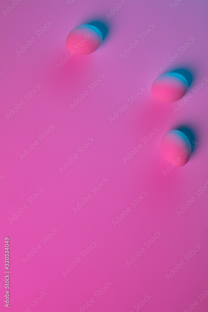 Egg hunt is coming. Easter traditions, pink-blue colored eggs on pink background, neon light, top view, copyspace for ad. Concept of holidays, spring, celebrating, food and sweets, family time. Egg hunt is coming. Easter traditions, pink-blue colored eggs on pink background, neon light, top view, copyspace for ad. Concept of holidays, spring, celebrating, food and sweets, family time.
