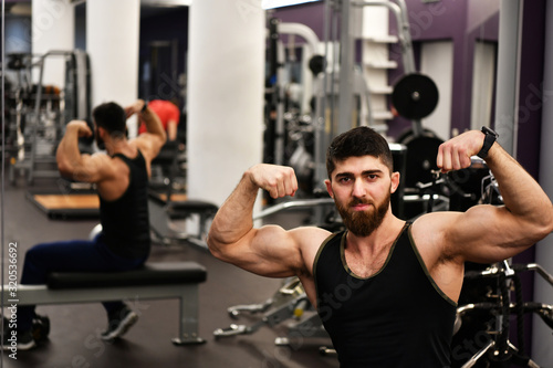 male athlete poses in the sports gym