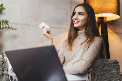 Photos Girl using bank card for buying things online