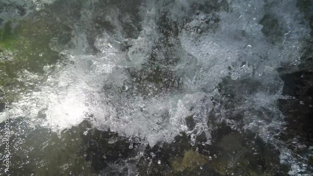 Rushing stream under snow mountain Rushing stream under snow mountain