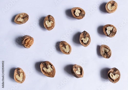 walnuts halfs with heart shape nuts pattern on white background