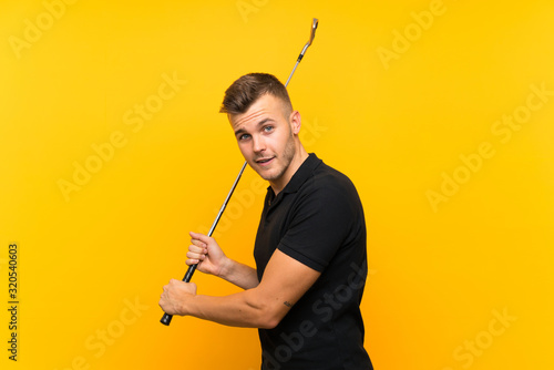 Golfer player man over isolated yellow background