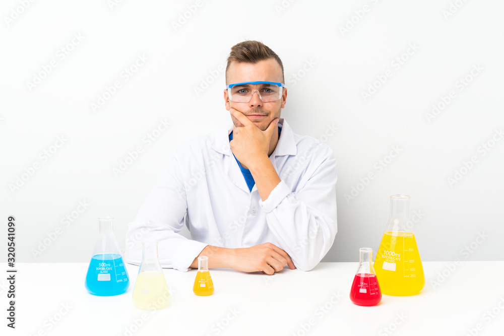 Young scientific with lots of laboratory flask laughing Young scientific with lots of laboratory flask laughing