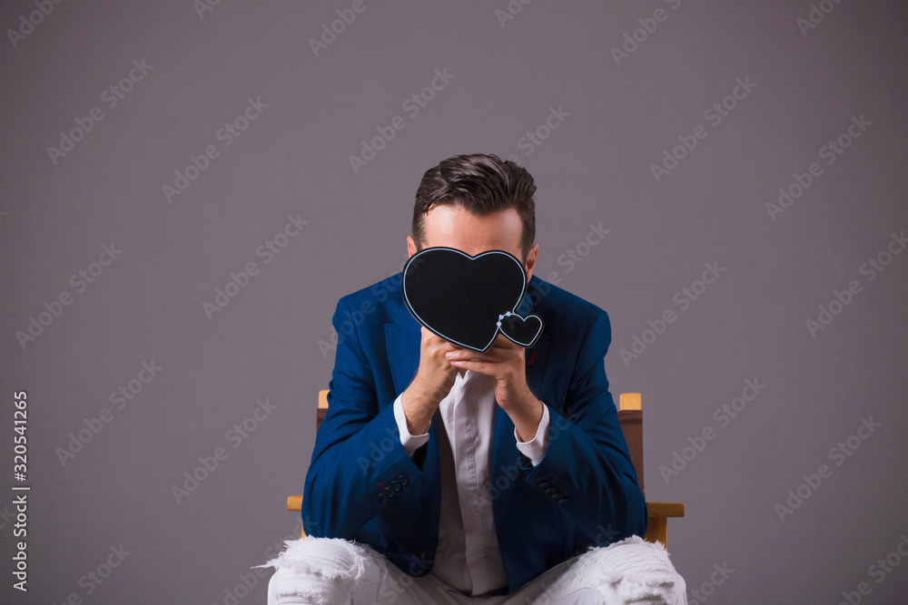 Playful man hiding behind heart shape. Playful man hiding behind heart shape.