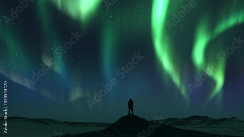 Animations of spectacular Bright realistic Aurora Borealis landscape. Tourist man on mountain.Time lapse clip of Polar Light or Northern Light in night sky. The movement of the star sky on background