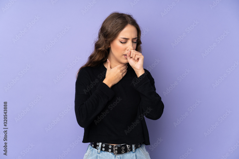 Young woman over isolated purple background is suffering with cough and feeling bad