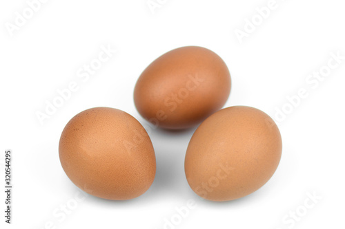 Three brown eggs separated with isolated from the white background